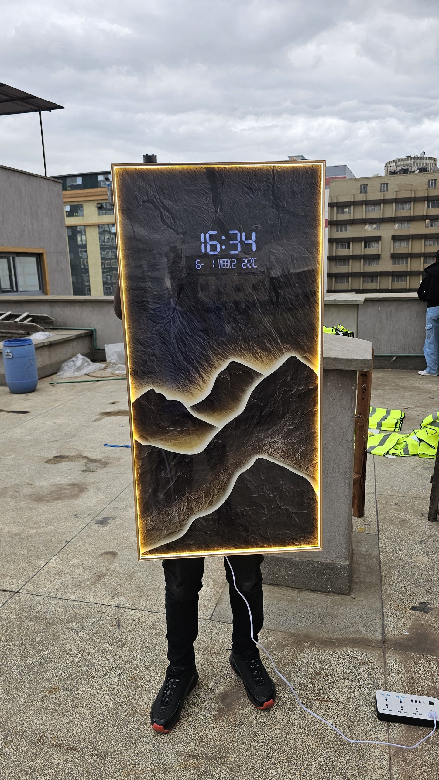 Bring modern elegance to your space with this LED Decorative Wall Clock featuring a stunning layered mountain landscape design and ambient warm backlighting.