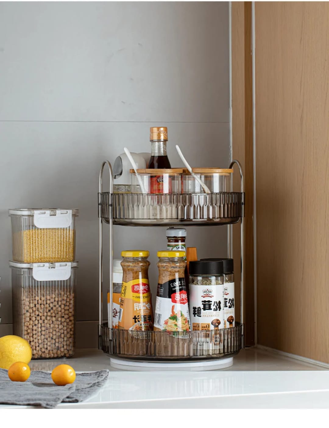2-tier rotating makeup organizer features clear acrylic trays with stylish metallic handles