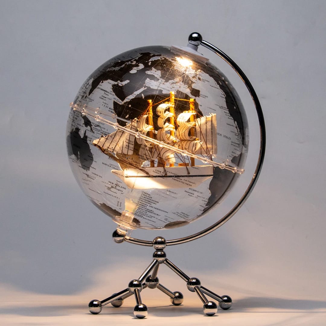 Illuminating LED world globe ornament with metal stand