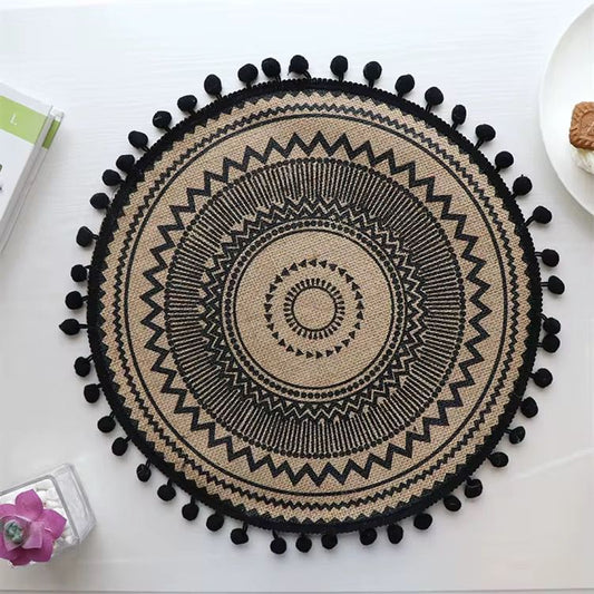 Beautiful round woven table mat with lace detail and pom-pom edges